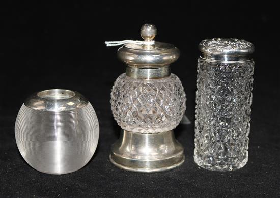 A silver mounted pepper grinder and silver mounted glass match striker and toilet jar.